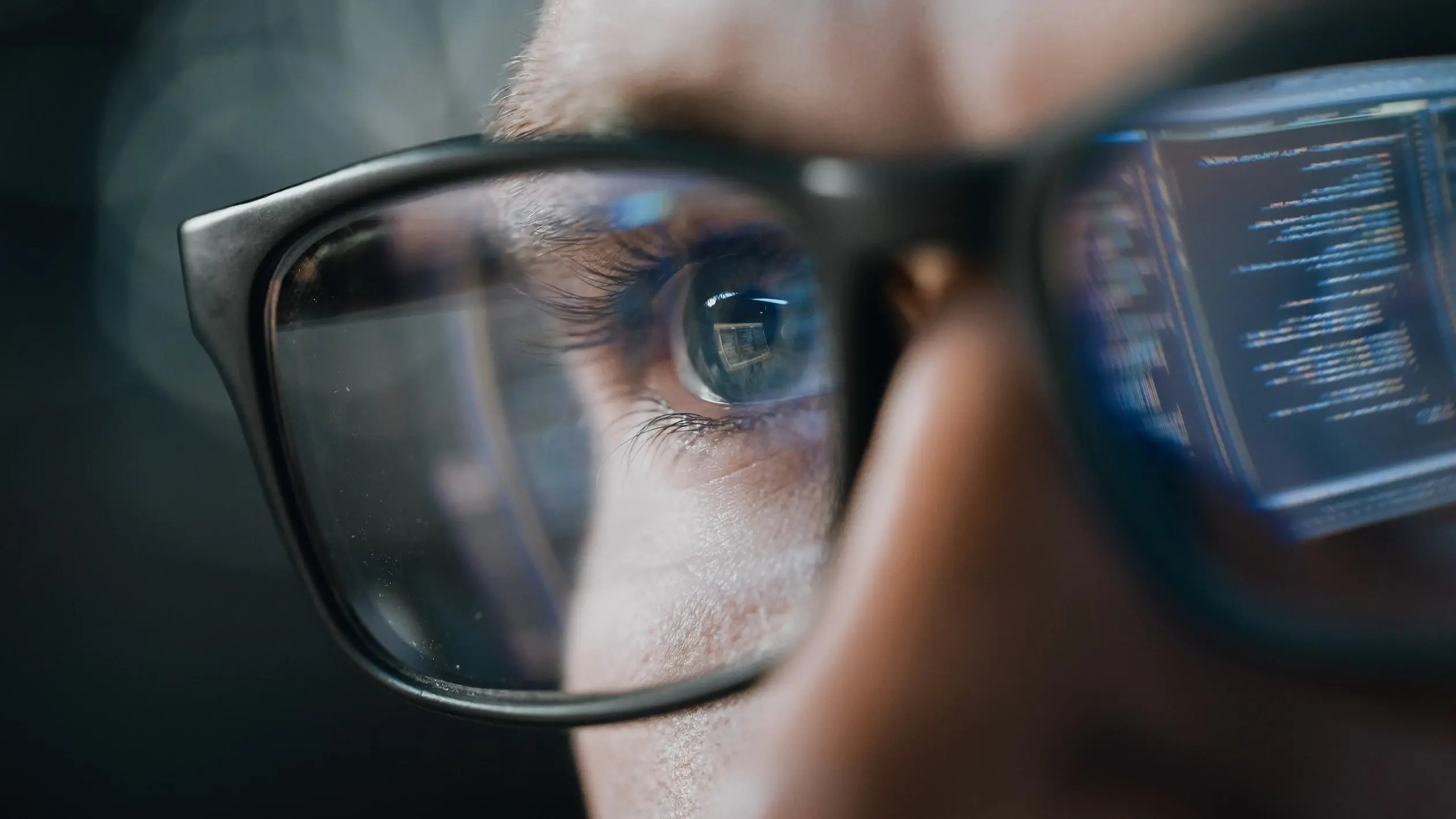person-at-computer-with-reflecting-glasses